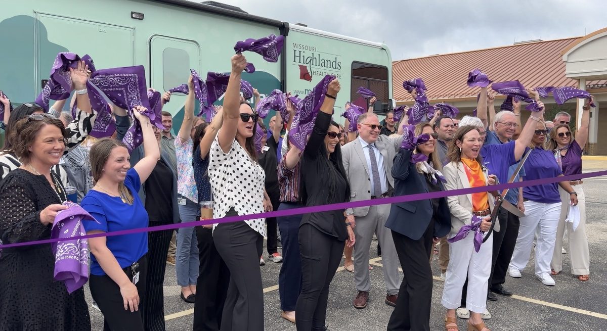 Partners celebrating with streamers at the ribbon cutting