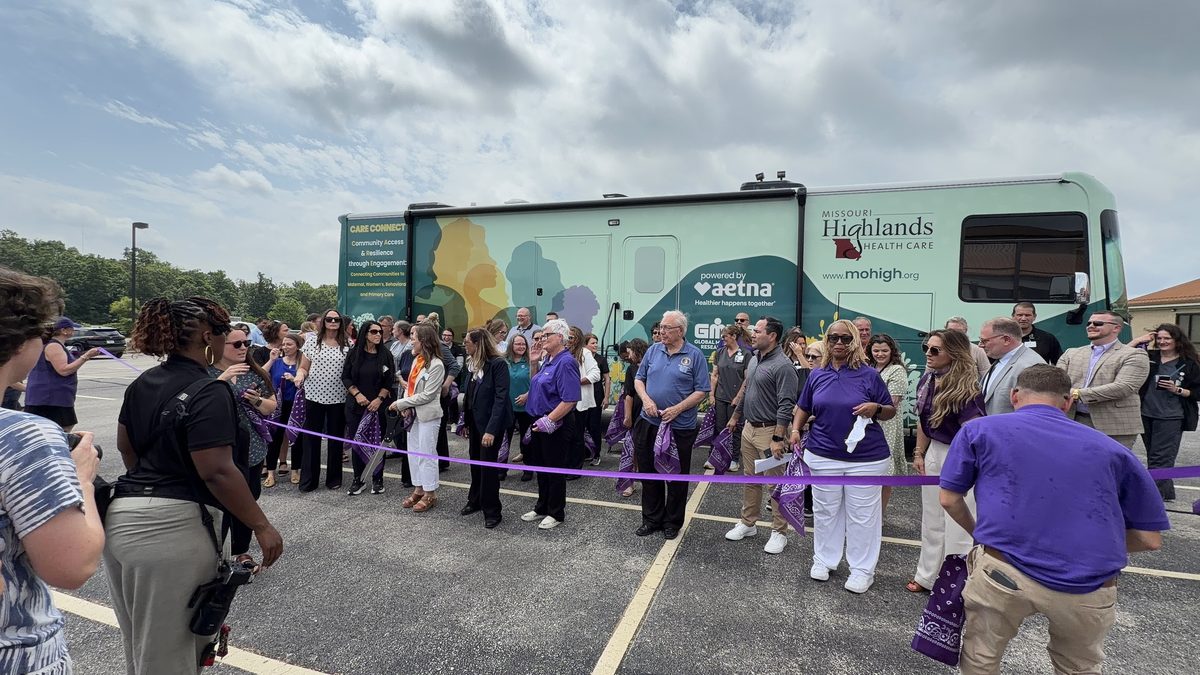 The launch crowd lined up along the ribbon in front of the unit